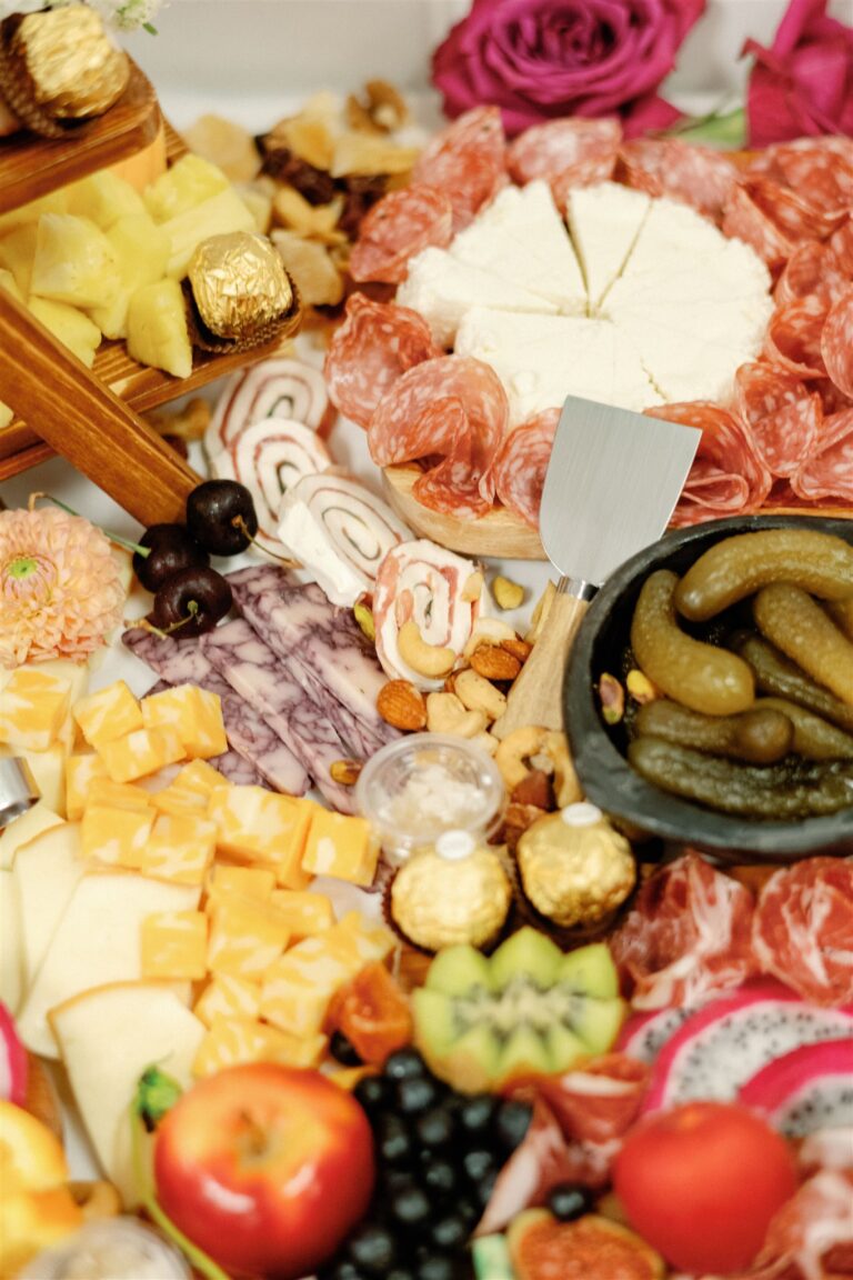 An elegantly arranged cheese and charcuterie board with fresh crudités, set against the backdrop of Andolina Intimate Venue in Duncanville, TX, ready for guests to enjoy. | Dallas, TX